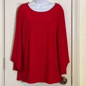 Red top by designer Dennis Basso with tulip sleeve cuffs.